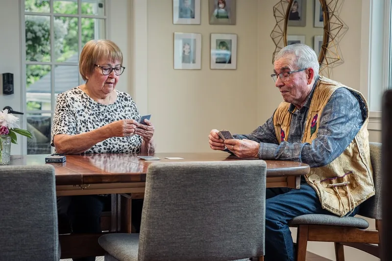 Card game, elderly couple, indoors, table
