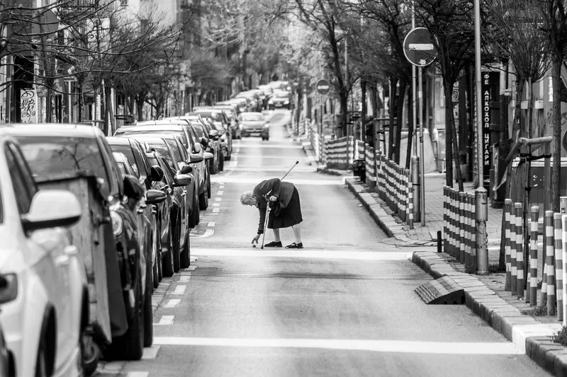 Urban, black and white, elderly woman, road